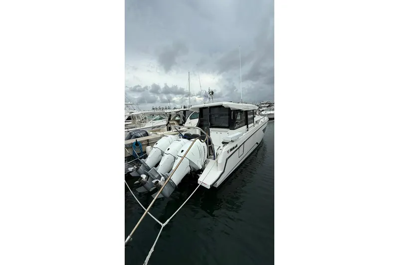 Slide: The Image of 2023 Wellcraft 355 boat docked in a marina under cloudy skies. - 3