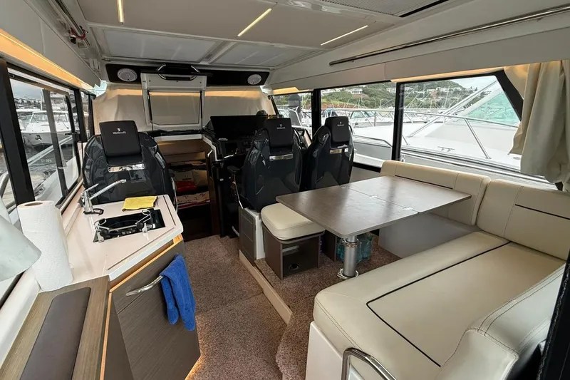 Slide: The Image of Interior of 2023 Wellcraft 355 boat with seating, table, and kitchenette. - 9