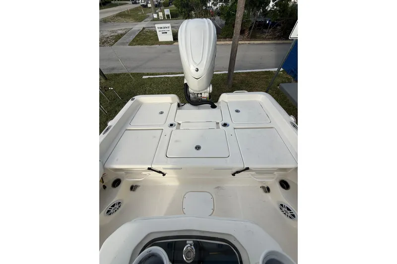Slide: The Image of 2026 Skeeter SX2550 Family boat deck with storage compartments and motor. - 16