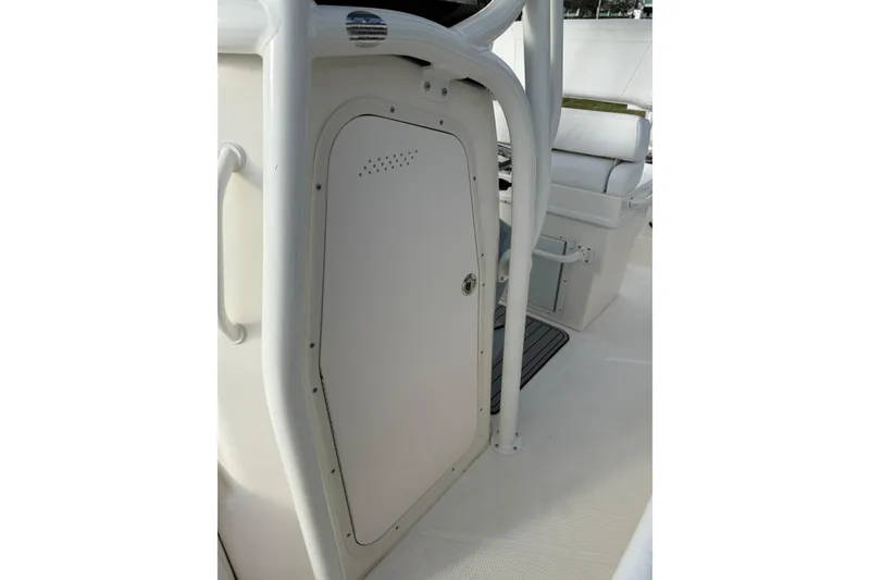 Slide: The Image of 2026 Skeeter SX2550 Family boat interior with white cabin door and seating area. - 18