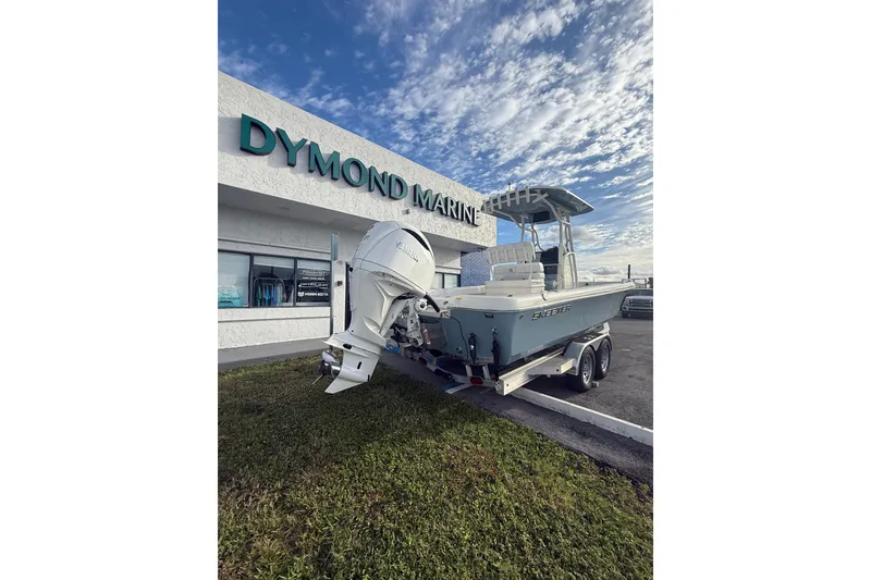 Slide: The Image of 2026 Skeeter SX2550 Family boat at Dymond Marine dealership, parked on a trailer. - 5