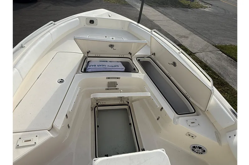 Slide: The Image of 2026 Skeeter SX2550 Family boat interior with open storage compartments and safety gear bag. - 8