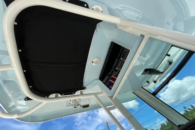 Slide: The Image of 2024 Boston Whaler 280 Outrage boat interior, featuring a sleek overhead console design. - 3