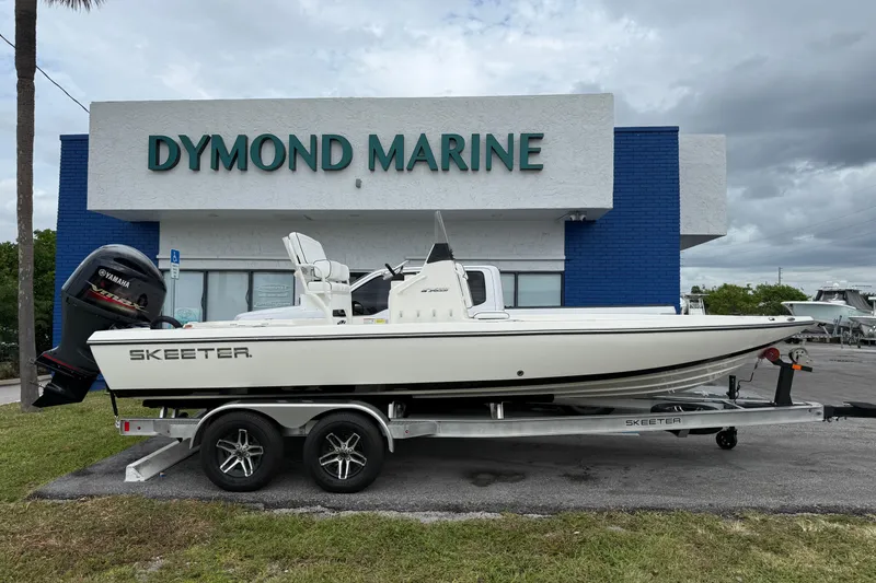 The Image of 2025 Skeeter SX221 boat on trailer outside Dymond Marine dealership. - 1