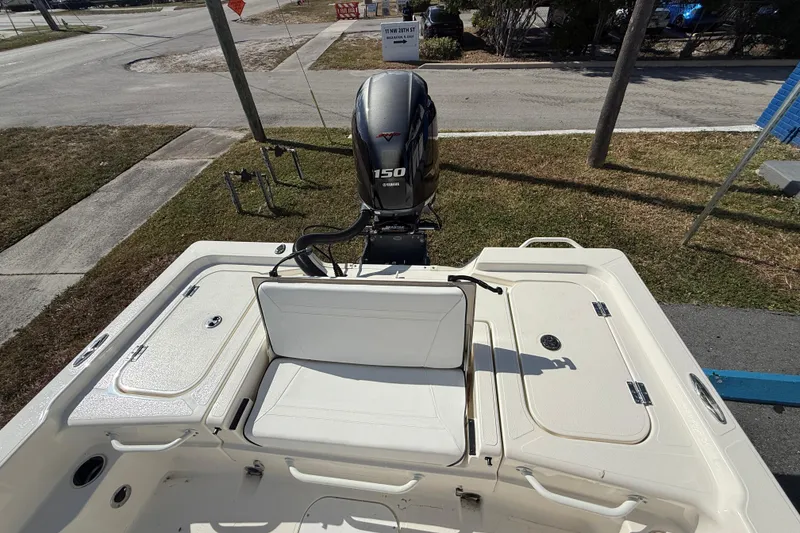 Slide: The Image of 2025 Skeeter SX221 boat with Yamaha 150 engine, parked on roadside. - 11