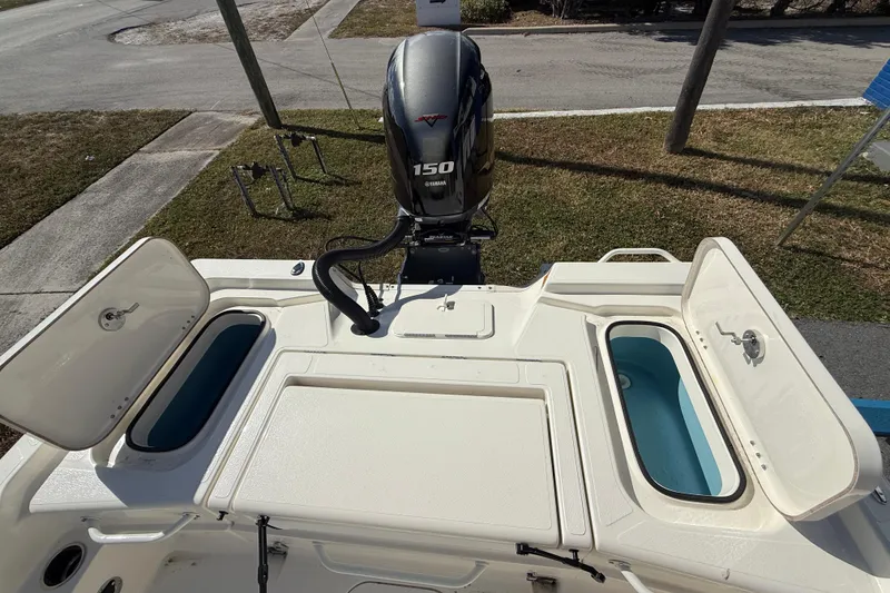 Slide: The Image of 2025 Skeeter SX221 boat with Yamaha 150 engine, open storage compartments. - 13
