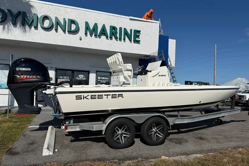 Slide: The Image of 2025 Skeeter SX221 boat on trailer outside marine dealership. - 4