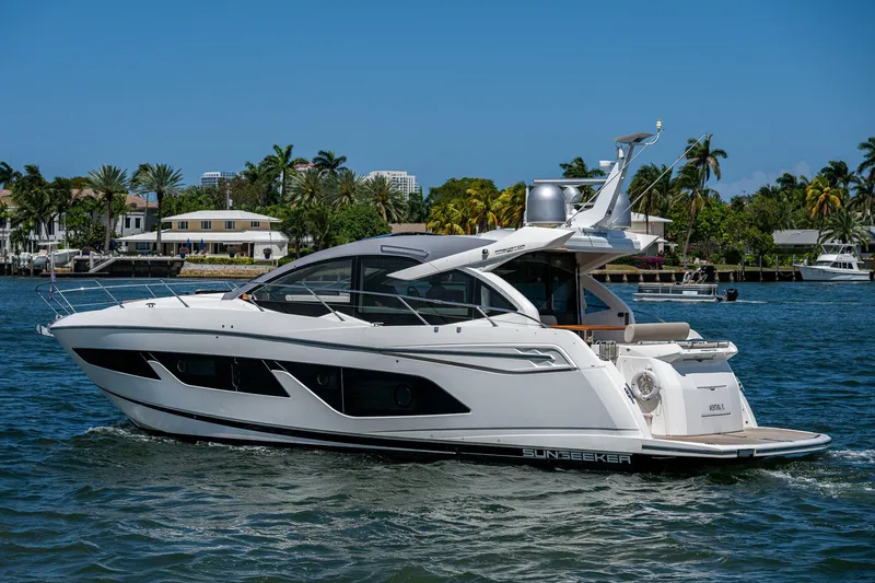 The Image of 2019 Sunseeker Predator 50 yacht cruising on a sunny day near palm-lined shore. - 0