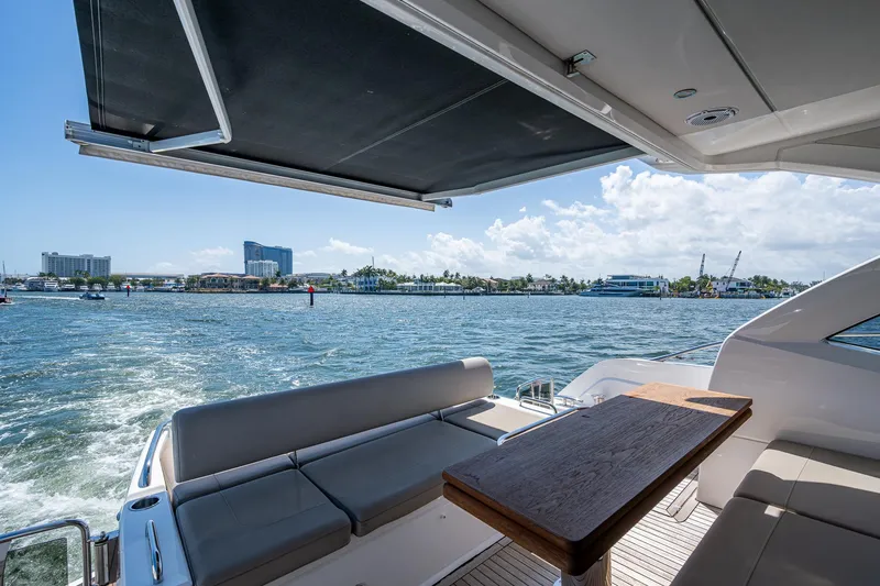 Slide: The Image of 2019 Sunseeker Predator 50 yacht with seating area, table, and ocean view. - 20