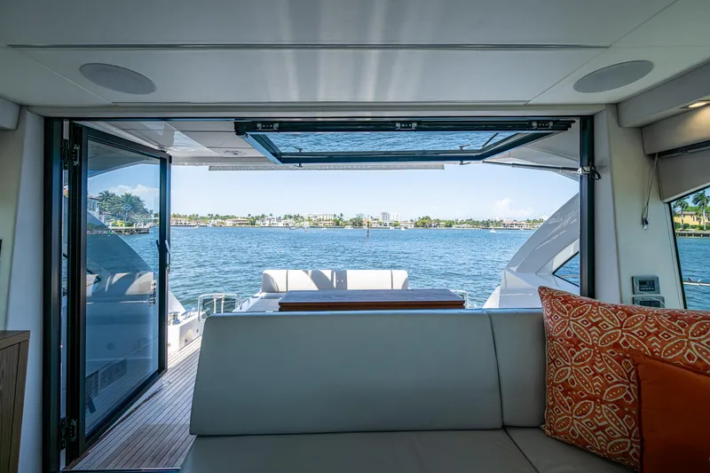 Slide: The Image of Interior view from a 2019 Sunseeker Predator 50 yacht, overlooking a serene waterfront. - 24