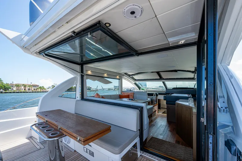 Slide: The Image of 2019 Sunseeker Predator 50 yacht interior with open seating and dining area. - 25