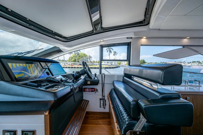 Slide: The Image of 2019 Sunseeker Predator 50 yacht interior with modern helm and luxurious seating. - 34