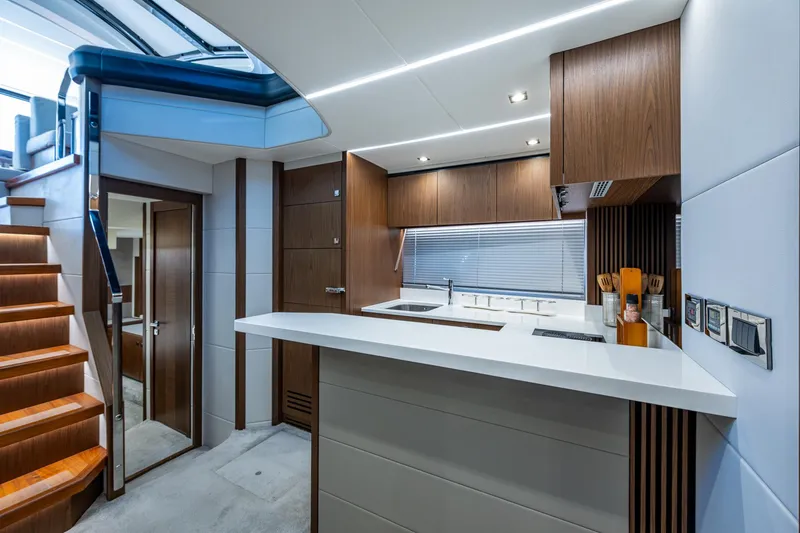 Slide: The Image of Modern kitchen interior of 2019 Sunseeker Predator 50 yacht with sleek wood finishes. - 45