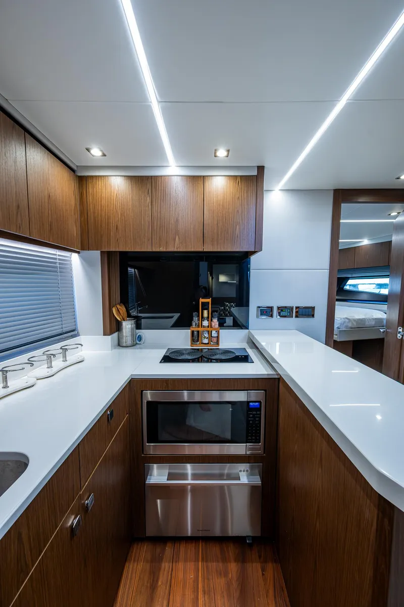 Slide: The Image of Luxurious 2019 Sunseeker Predator 50 yacht kitchen with modern appliances and sleek wood cabinetry. - 46