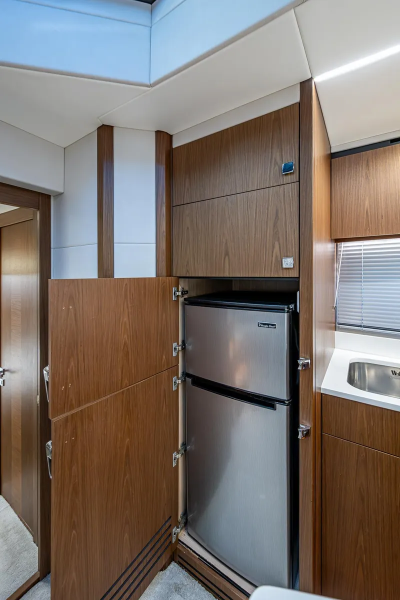 Slide: The Image of 2019 Sunseeker Predator 50 yacht interior with modern kitchen and stainless steel fridge. - 48