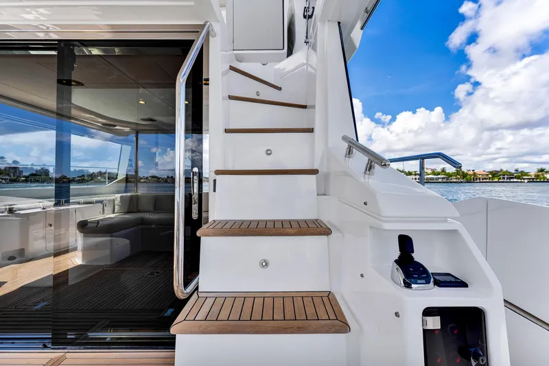 Slide: The Image of Azimut Fly 60 yacht, 2022 model, featuring elegant stairs and luxurious interior with ocean view. - 24