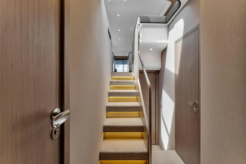 Slide: The Image of Interior staircase of 2022 Azimut Fly 60 yacht, featuring modern design and ambient lighting. - 40