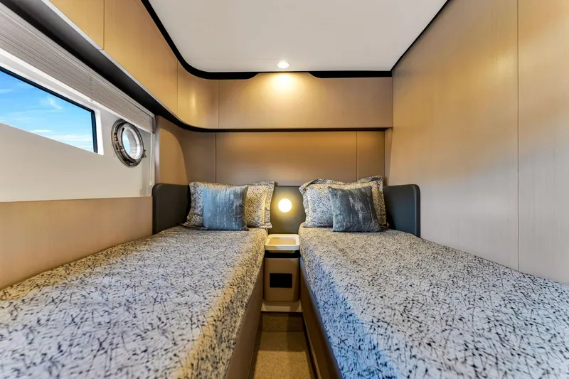 Slide: The Image of Luxurious twin cabin interior on 2022 Azimut Fly 60 yacht, featuring modern design and cozy bedding. - 44