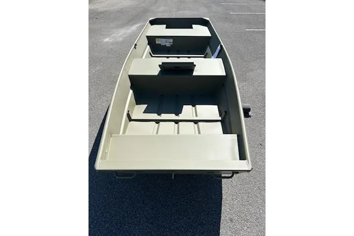 Slide: The Image of 2026 Tracker Grizzly 15 Jon boat on asphalt, showcasing interior seating and storage. - 2