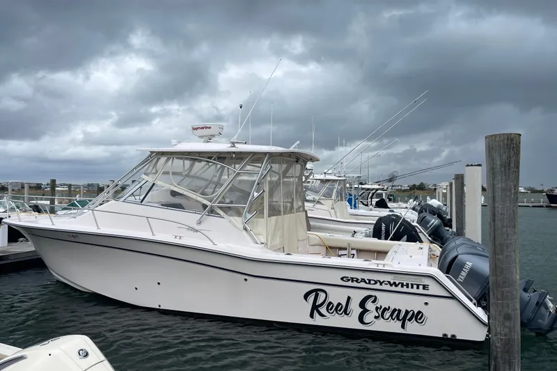 The Image of 2007 Grady-White Express 330 boat docked under cloudy skies. - 0