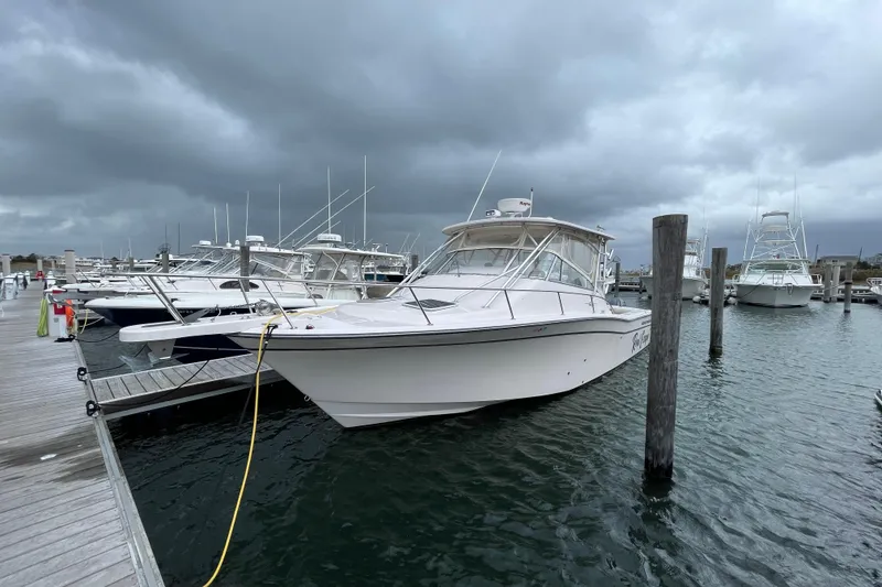 Slide: The Image of 2007 Grady-White Express 330 boat docked at marina under cloudy skies. - 1