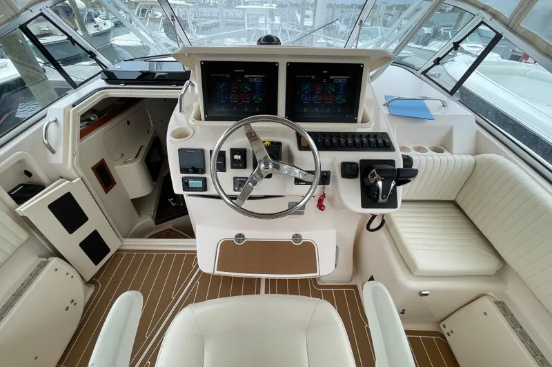 Slide: The Image of 2007 Grady-White Express 330 helm with modern controls and dual screens. - 11