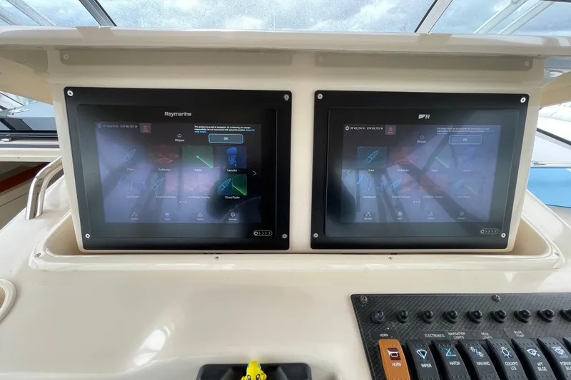 Slide: The Image of Dual Raymarine displays on 2007 Grady-White Express 330 boat dashboard. - 12