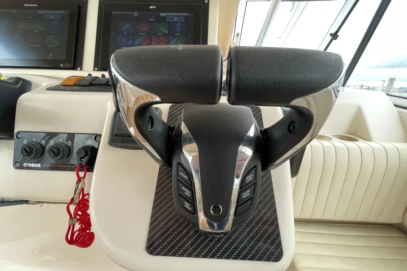 Slide: The Image of Throttle controls on a 2007 Grady-White Express 330 boat dashboard. - 15