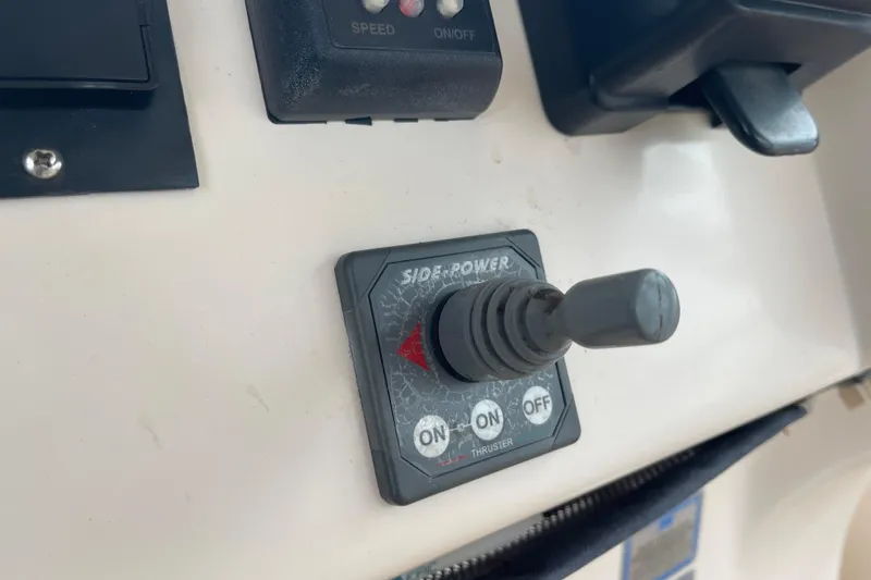 Slide: The Image of Control panel of a 2007 Grady-White Express 330 boat with Side-Power thruster switch. - 17