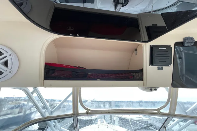 Slide: The Image of 2007 Grady-White Express 330 boat interior with storage compartment and Raymarine equipment. - 22