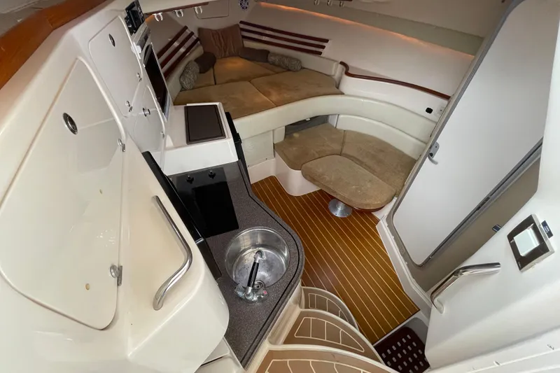 Slide: The Image of 2007 Grady-White Express 330 cabin interior with kitchenette and seating area. - 24