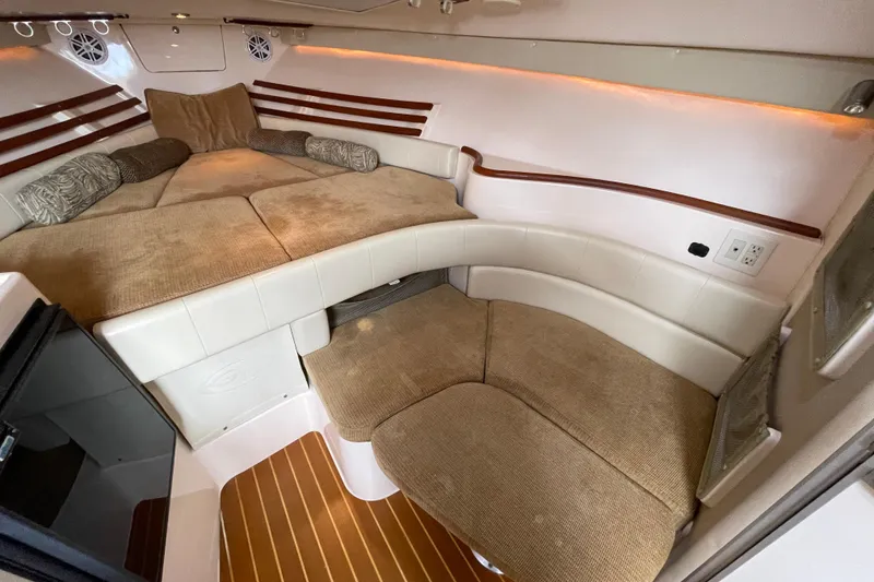 Slide: The Image of 2007 Grady-White Express 330 cabin interior with cozy seating and elegant wood accents. - 26