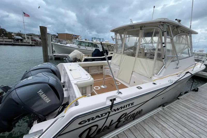 Slide: The Image of 2007 Grady-White Express 330 boat docked with Yamaha engines, overcast sky. - 3