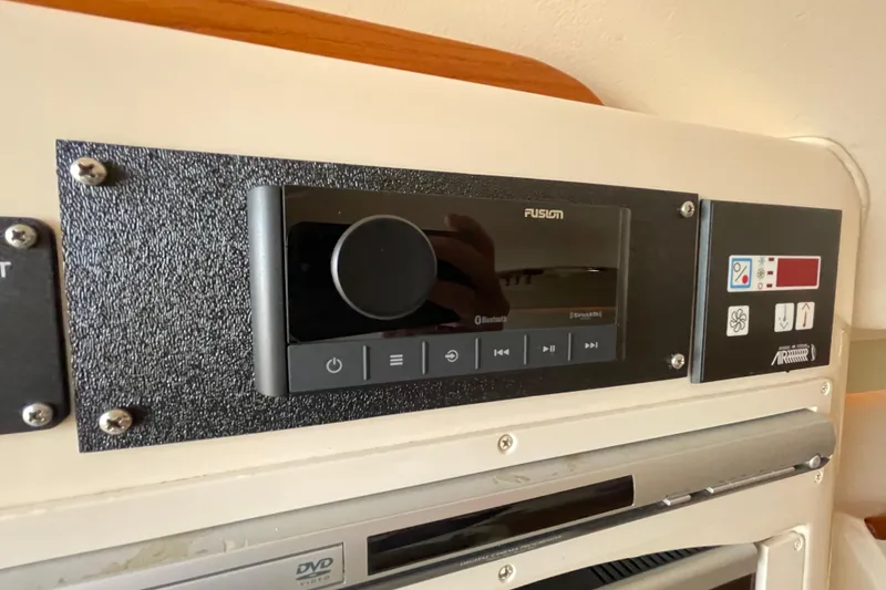 Slide: The Image of 2007 Grady-White Express 330 boat control panel with Fusion audio system. - 34