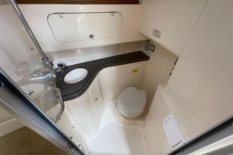 Slide: The Image of 2007 Grady-White Express 330 boat bathroom with sink, toilet, and storage. - 36