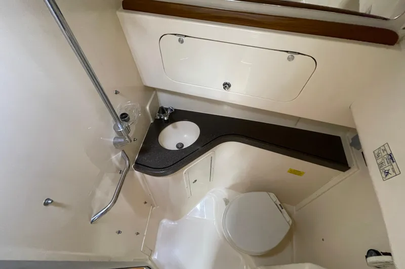 Slide: The Image of 2007 Grady-White Express 330 boat bathroom with sink, toilet, and storage. - 37