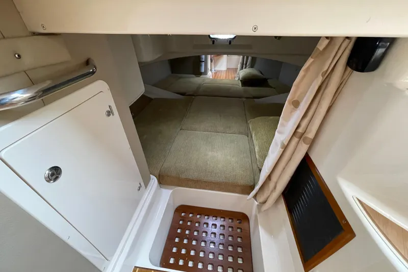 Slide: The Image of 2007 Grady-White Express 330 cabin interior with cozy sleeping area and storage. - 38