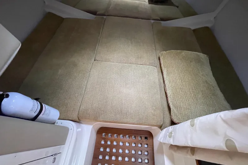 Slide: The Image of 2007 Grady-White Express 330 cabin interior with cushioned seating and fire extinguisher. - 39