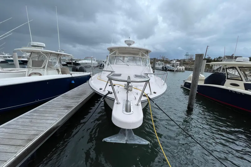 Slide: The Image of 2007 Grady-White Express 330 boat docked at marina under cloudy skies. - 4