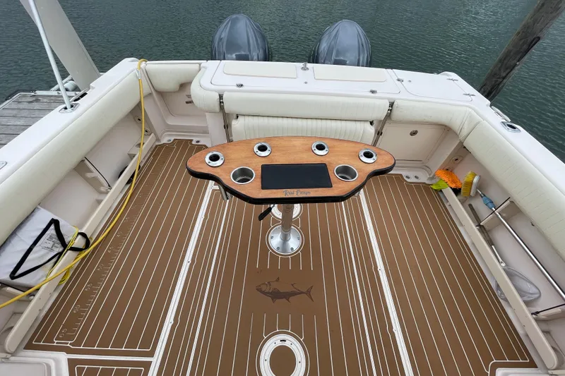 Slide: The Image of 2007 Grady-White Express 330 boat deck with table and seating, docked by the water. - 41