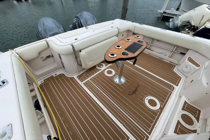 Slide: The Image of 2007 Grady-White Express 330 boat interior with custom deck and table, docked by the water. - 43