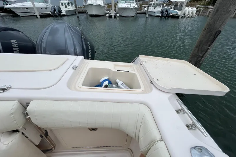 Slide: The Image of 2007 Grady-White Express 330 boat with open storage compartment at marina. - 46