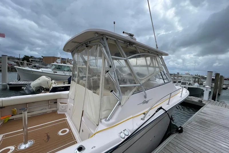 Slide: The Image of 2007 Grady-White Express 330 boat docked at marina under cloudy sky. - 5