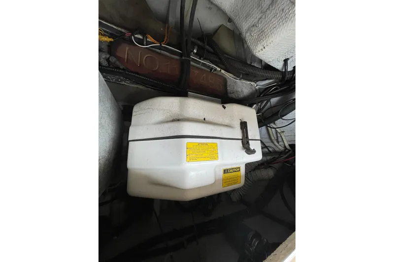 Slide: The Image of Engine compartment of 2007 Grady-White Express 330 boat, featuring a white plastic component. - 51