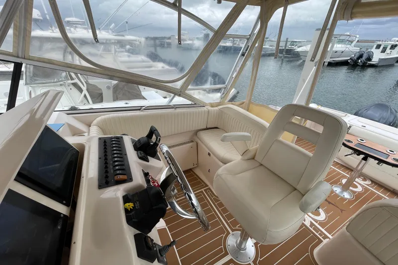 Slide: The Image of 2007 Grady-White Express 330 boat interior with helm, seating, and marina view. - 7