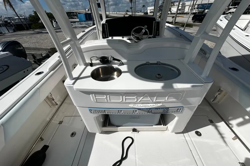 Slide: The Image of 2018 Robalo R302 Center Console boat interior with sink and storage. - 4
