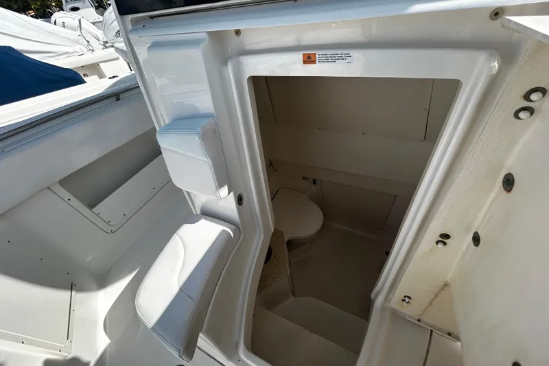 Slide: The Image of 2018 Robalo R302 Center Console boat interior with compact restroom. - 6