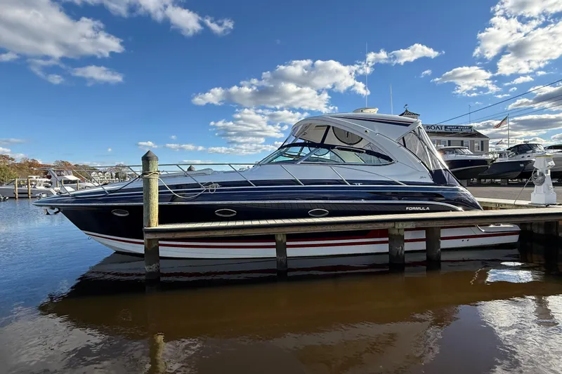 The Image of 2015 Formula 37 Performance Cruiser on calm water, sleek design, overcast sky. - 0