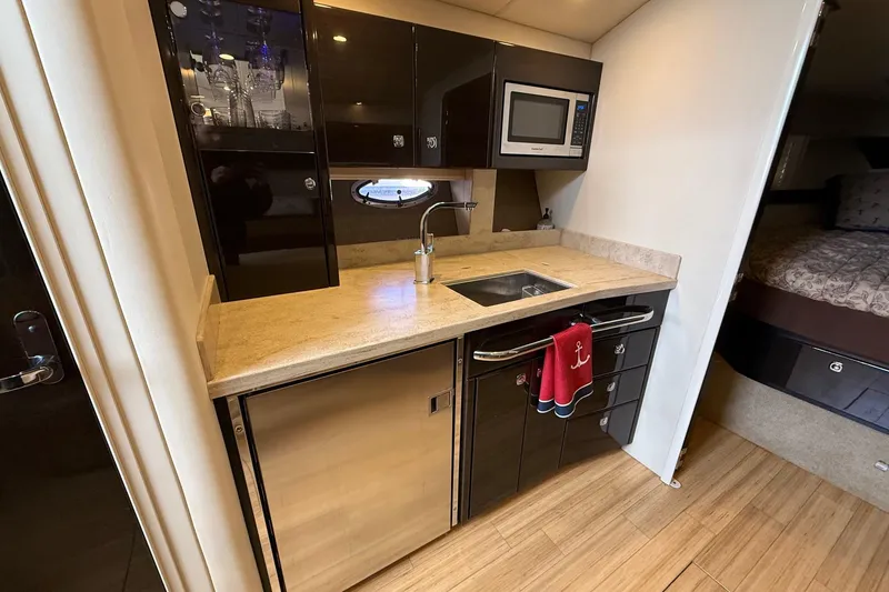 Slide: The Image of 2015 Formula 37 Performance Cruiser docked at marina under clear blue sky. - 13