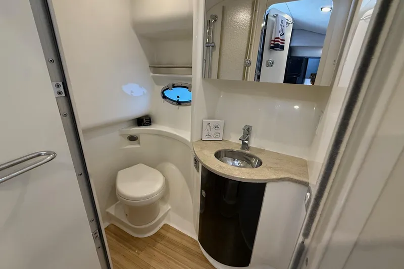 Slide: The Image of 2015 Formula 37 Performance Cruiser bathroom with sink, toilet, and porthole window. - 34